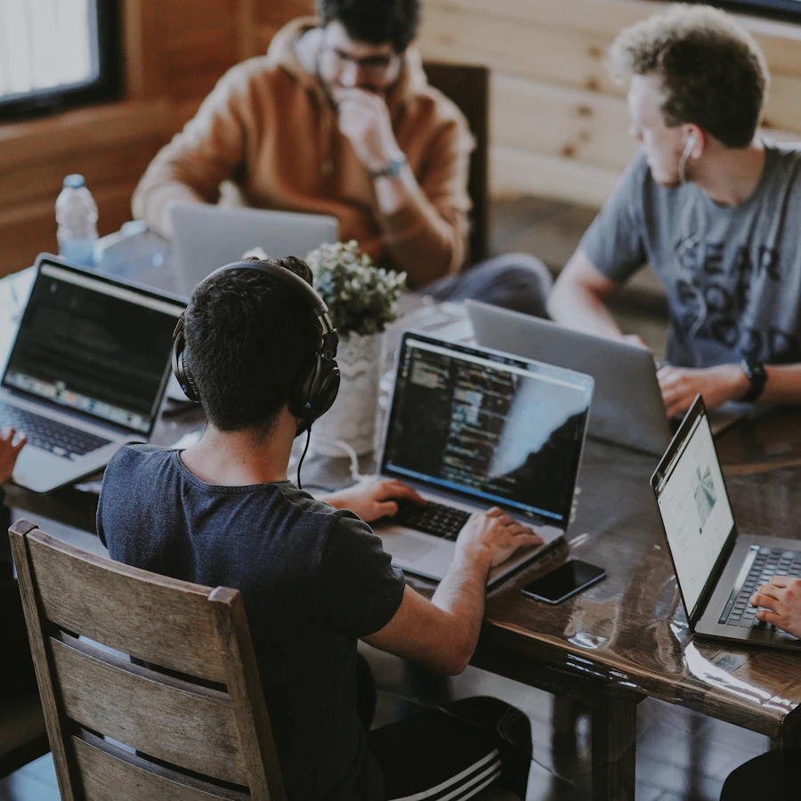 Small founder team working at a bright shared table
